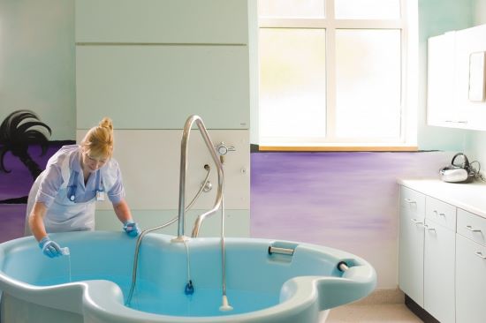 Midwife filling a birth pool